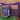 Two candles labeled 'Midnight in Paris' with purple ribbons on a wooden surface.